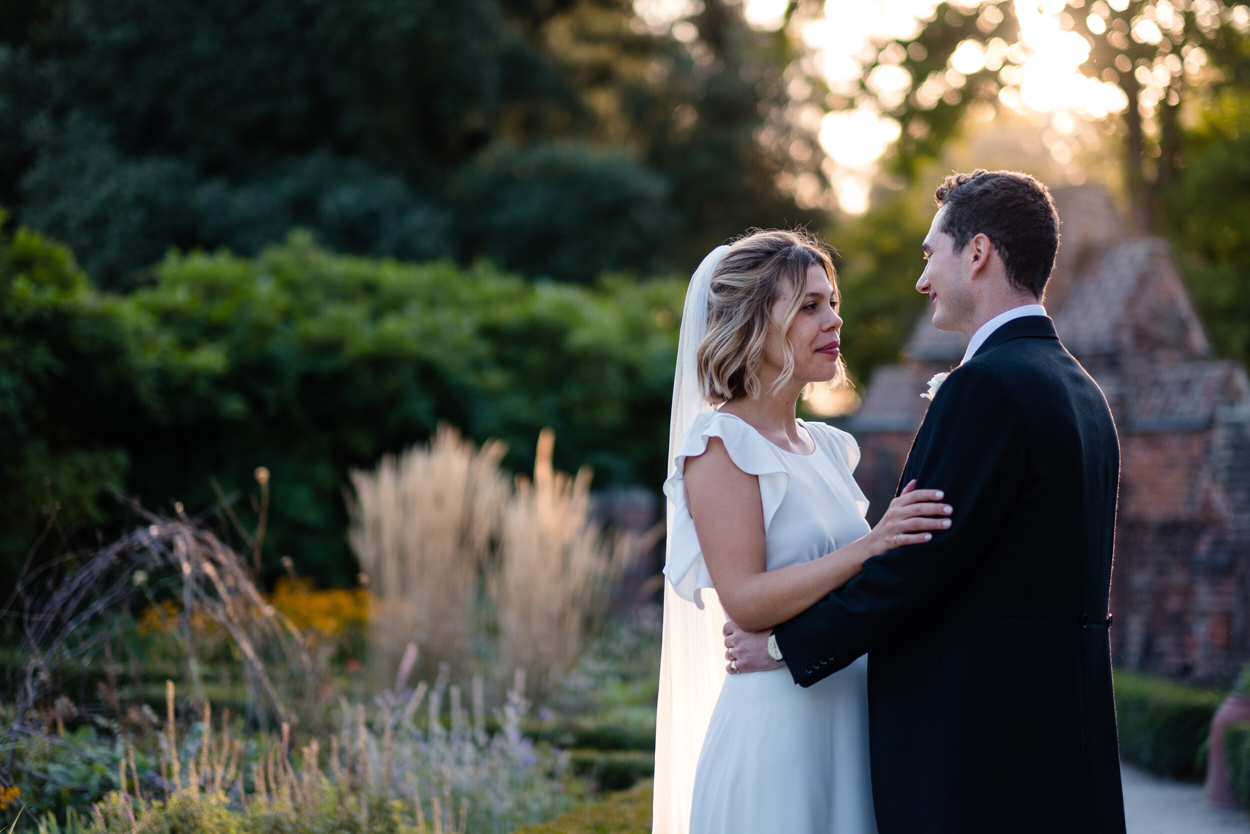 couple shot sunset Fulham Palace wedding in walled garden