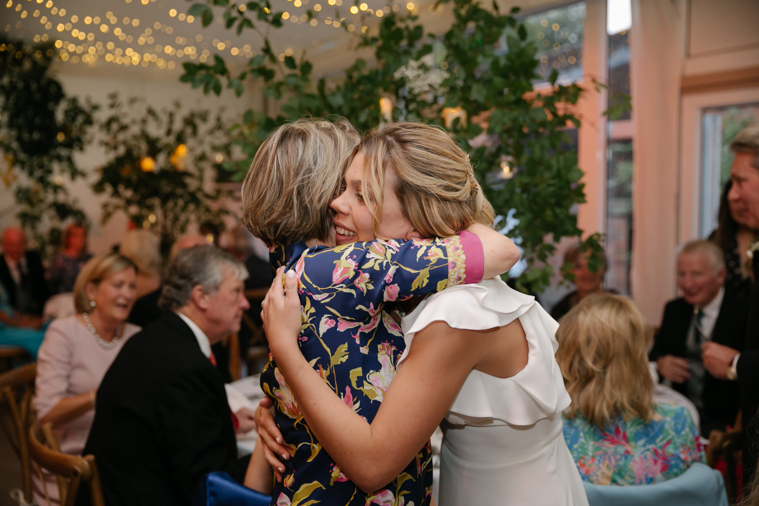 bride and mother hugging at wedding