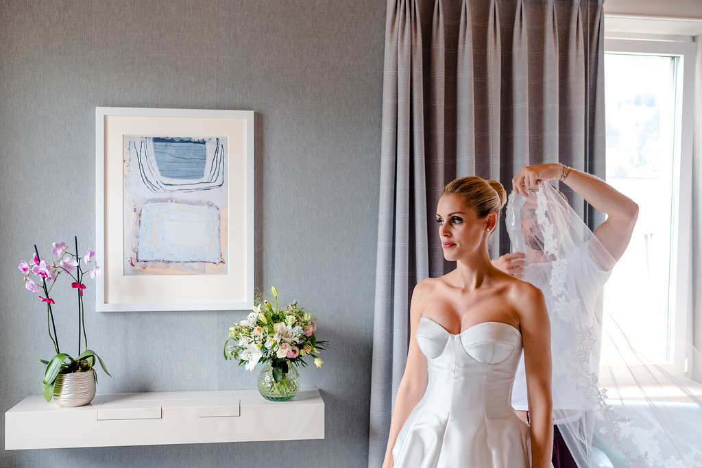 bride having veil attached wedding photography st moritz