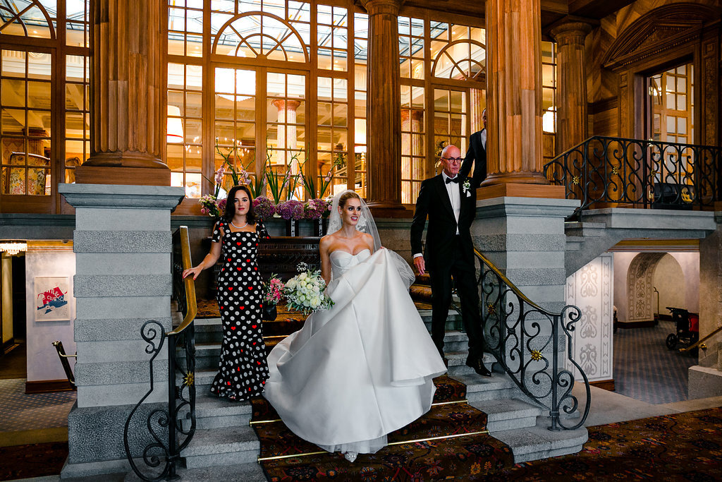 bride walking down stairs at Kulm hotel st moritz