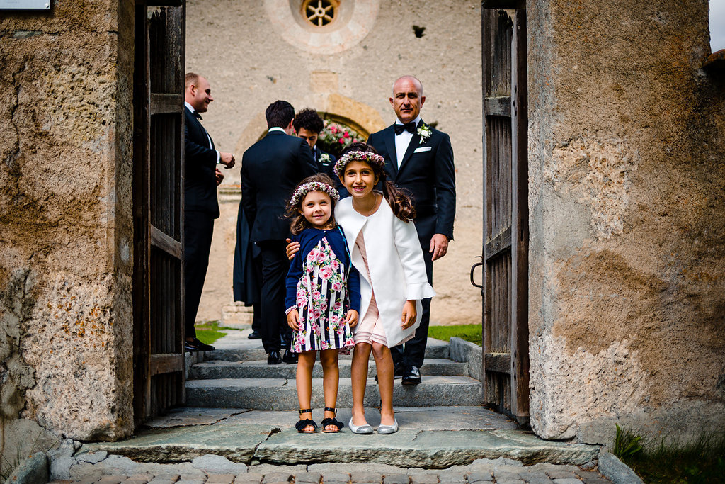 bridesmaids waiting on step of San Gian church Celerina