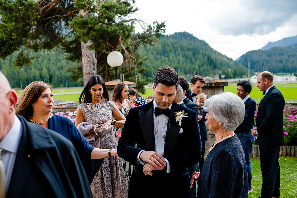 groom waiting outside church. wedding photography st moritz