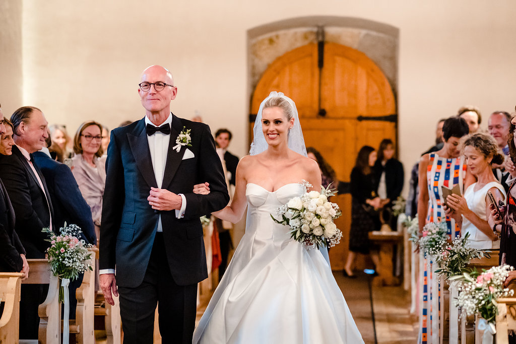 father walking bride up the aisle of San Gian church in Celerina