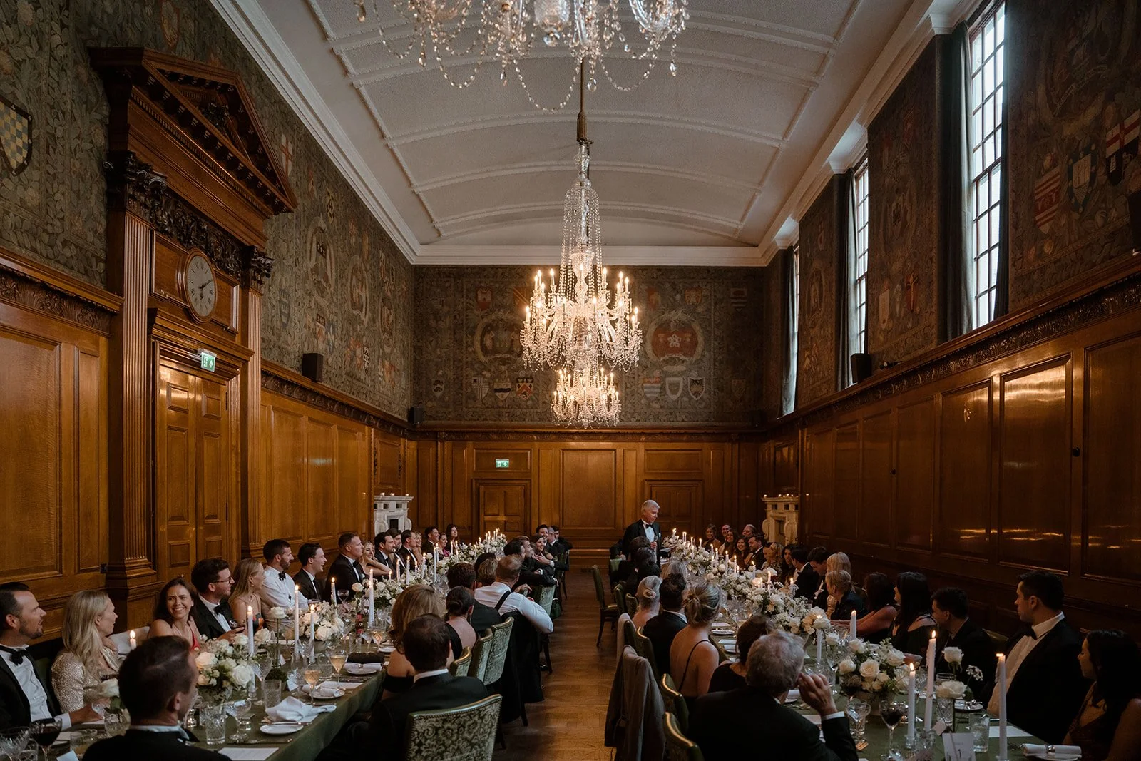 long dining table set for wedding reception at The Ned London with chandeliers and guests seated
