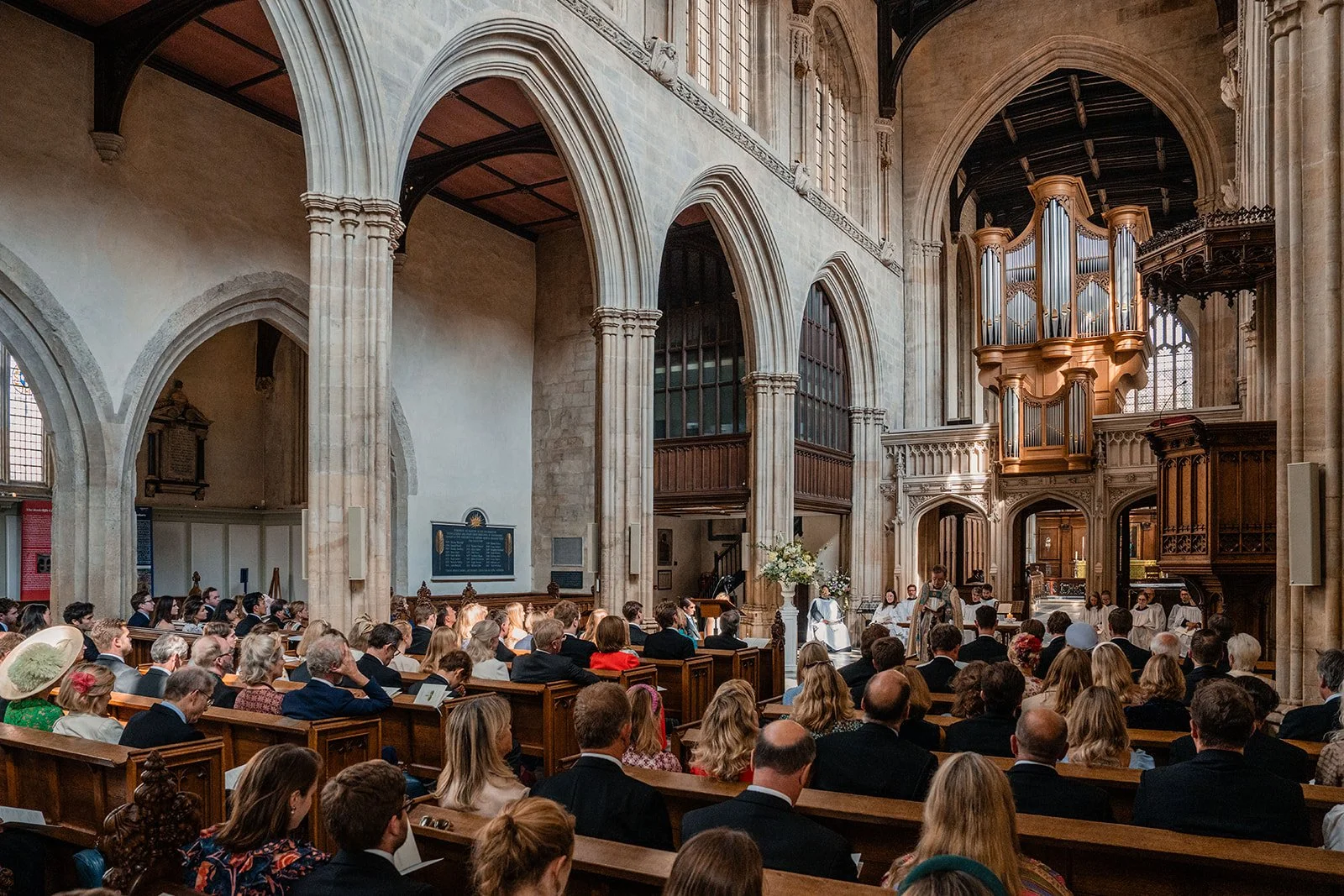 wedding ceremony inside St Mary’s Church Oxford with guests seated and couple at altar