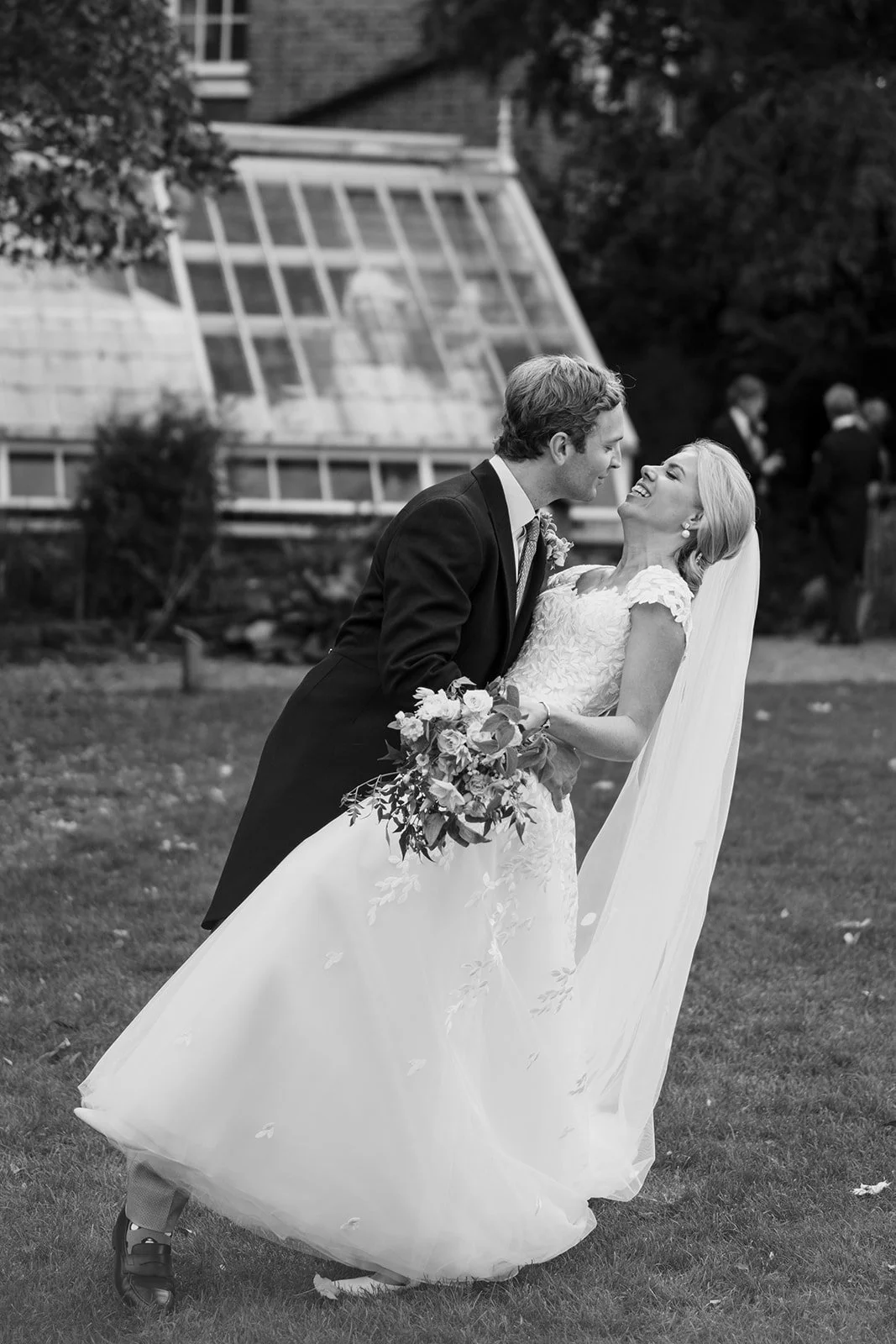 Bride and groom portrait in front of the glasshouse at Chelsea Physic Garden during a London garden wedding.