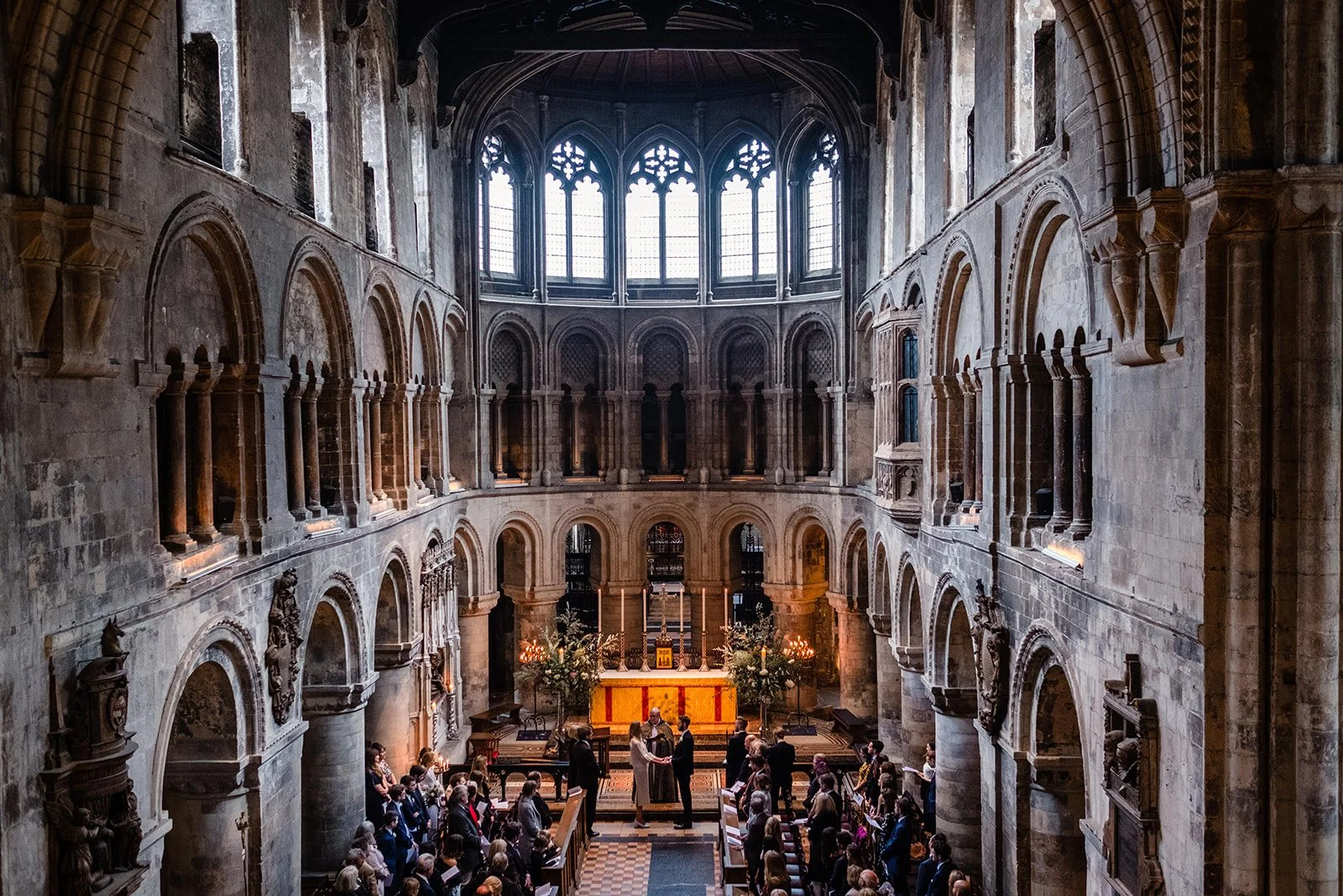 Wide interior view of St Bartholomew the Great during wedding ceremony in London