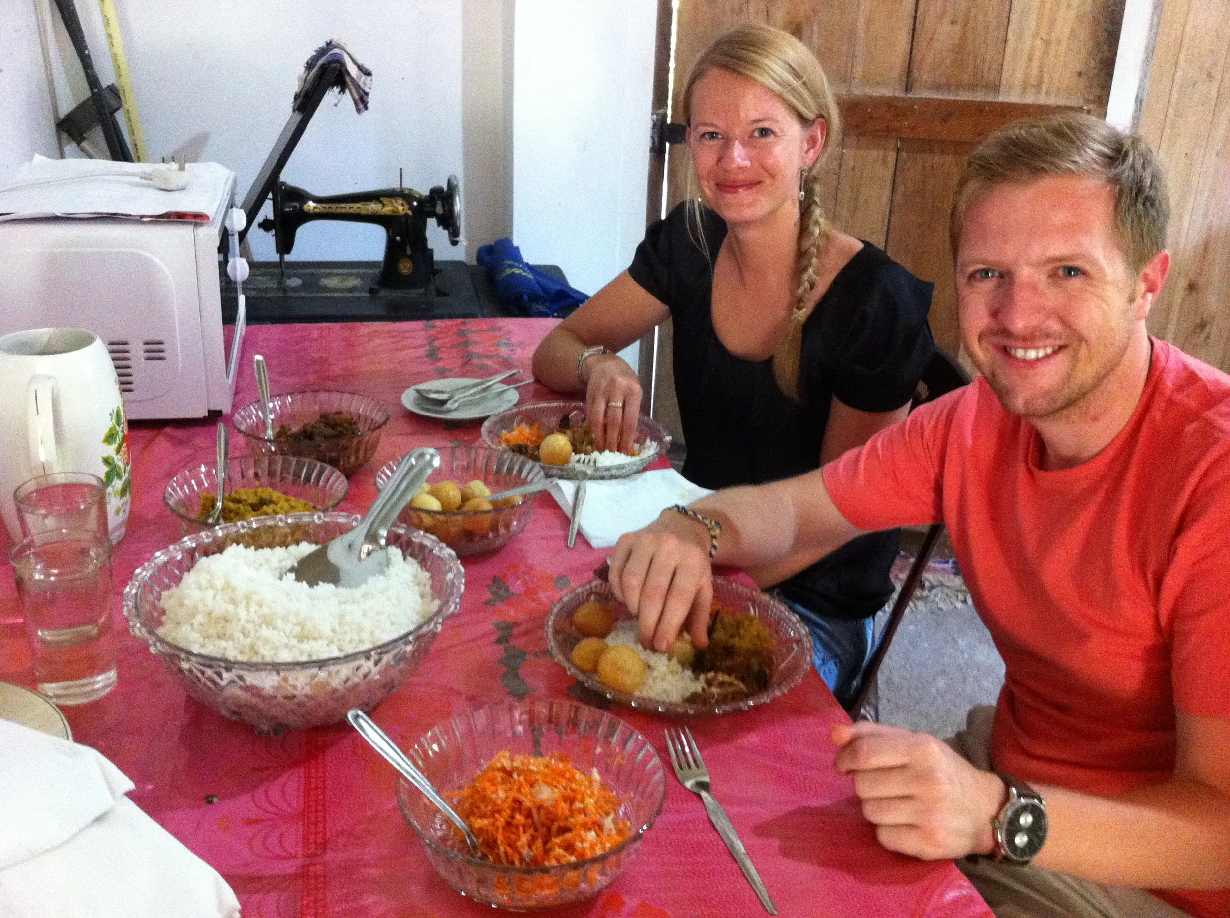 Invite to Paradise founders, and husband and wife, Reece and Claire Turvill in rural Sri Lanka having local rice and curry.