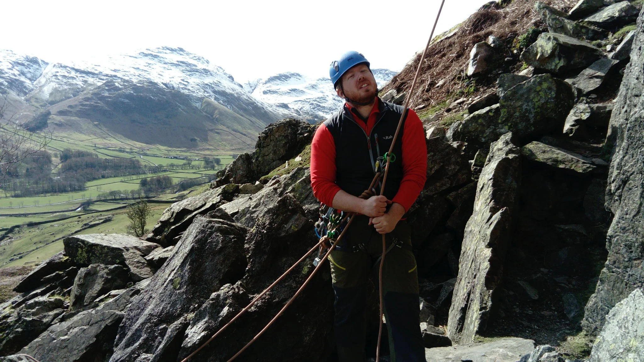 Nathan belaying at the bottom of Stickle Barn crag using a ground anchor