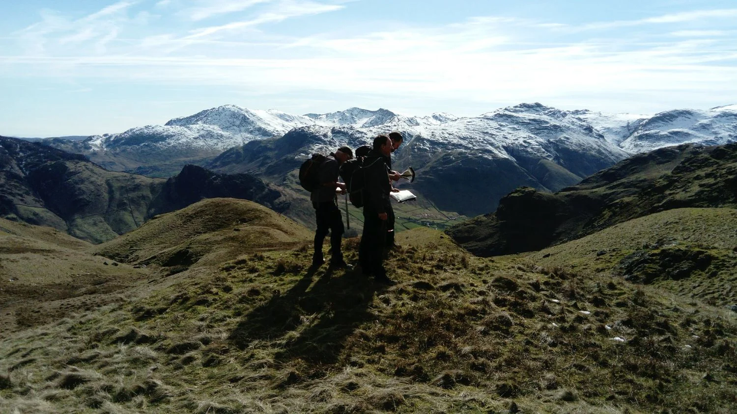 three people navigating in the mountains using contour-only maps - Chris Ensoll Mountain Guide