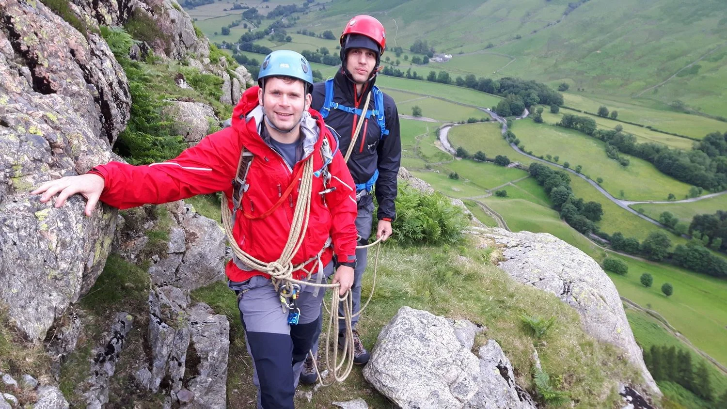 Two people with coils of rope scrambling in the Lake District – Chris Ensoll Mountain Guide