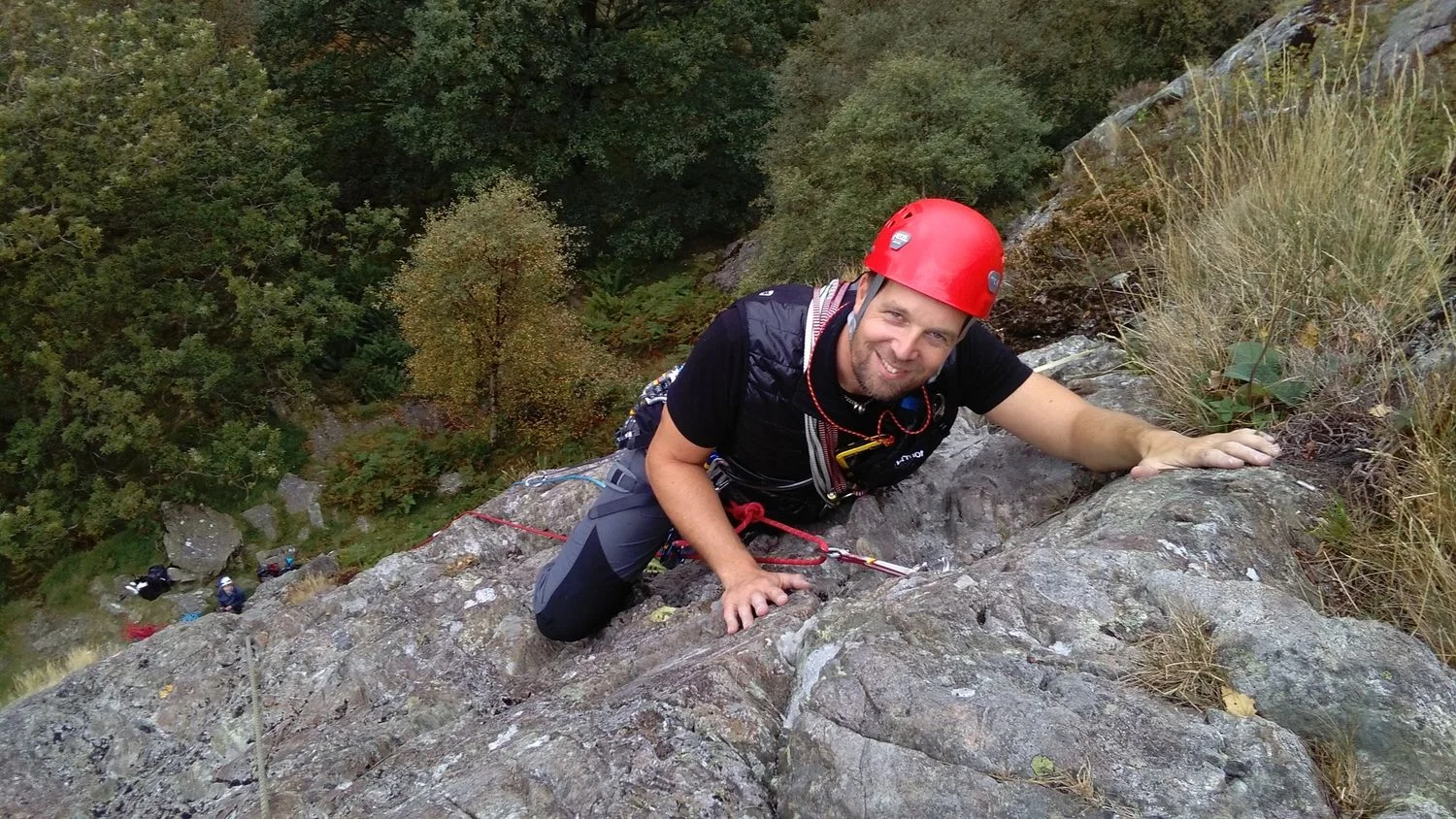 A rock climber learning how to lead a route in the Lake District - Chris Ensoll Mountain Guide