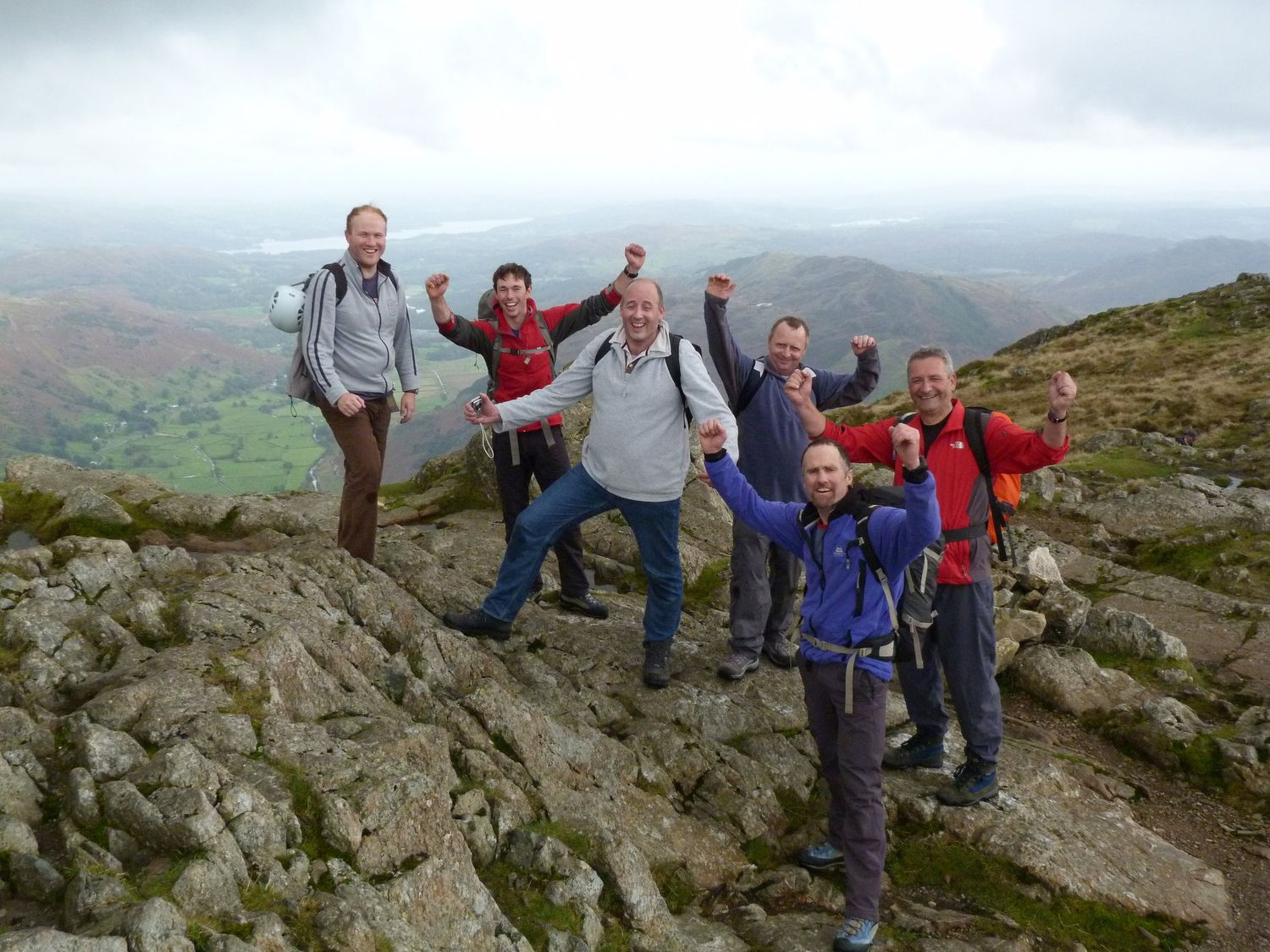  A group of clients celebrating success at the top of a rock climb - Chris Ensoll Mountain Guide 