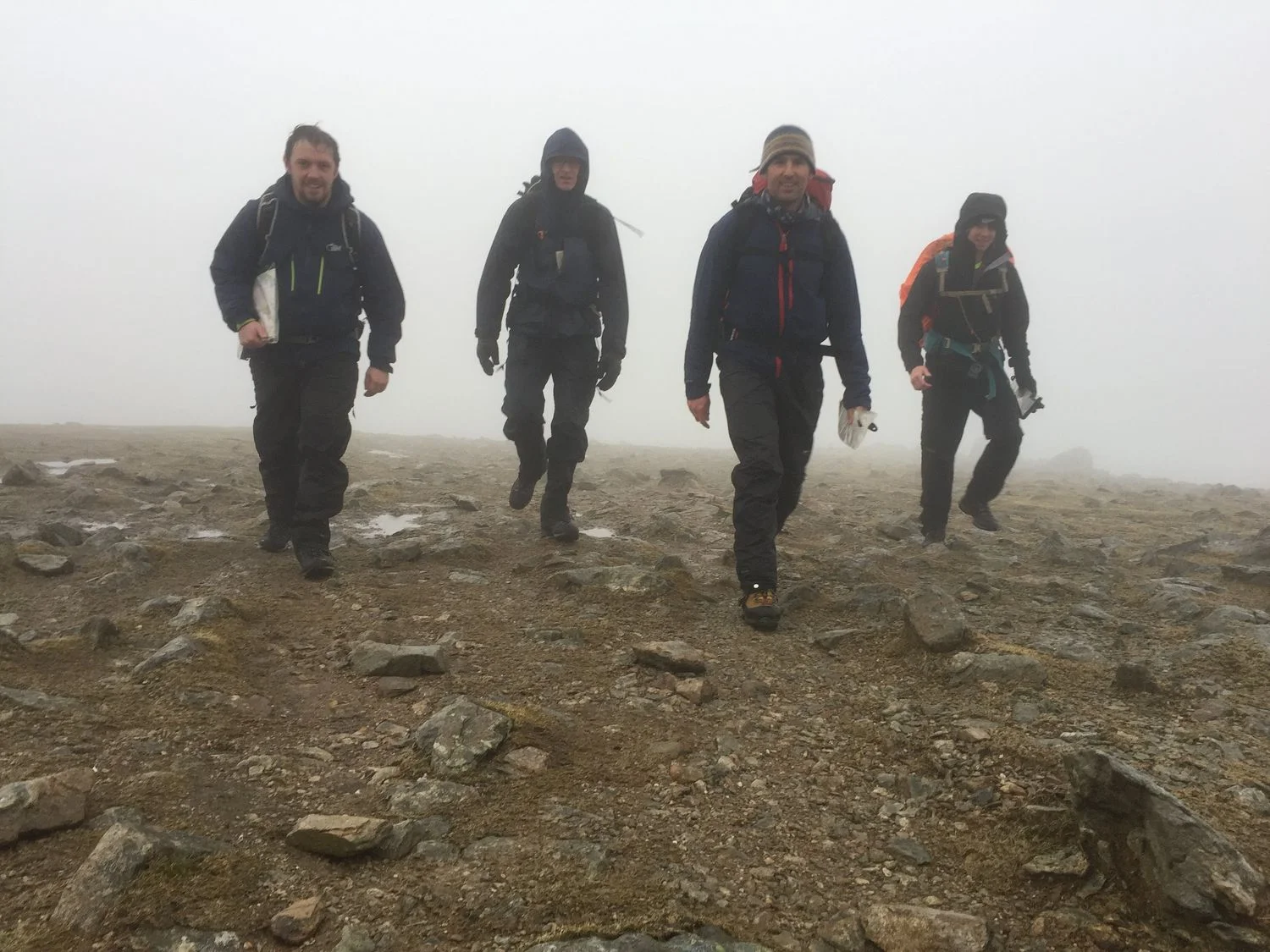 Four mountain walkers in the rain