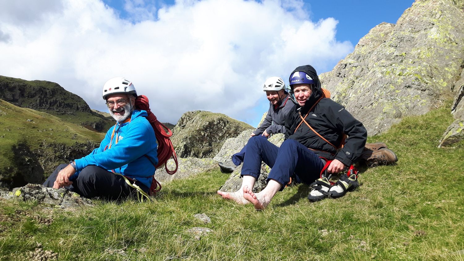  A group of clients savouring success at the top of a multi pitch rock climb in the Lake District - Chris Ensoll Mountain Guide 