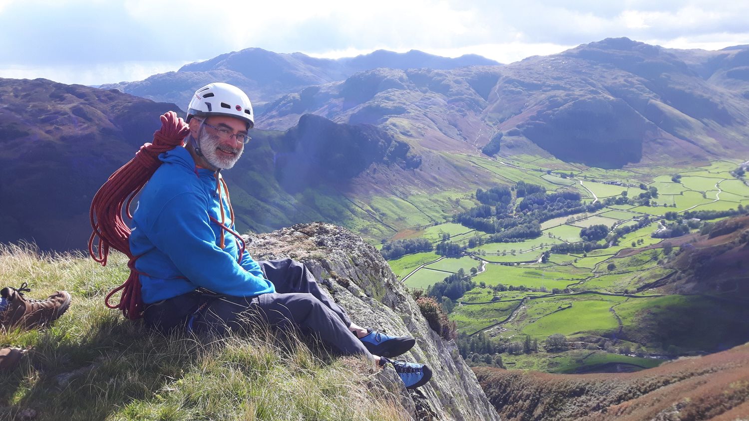  A client savouring success at the top of a multi pitch rock climb in the Lake District - Chris Ensoll Mountain Guide 