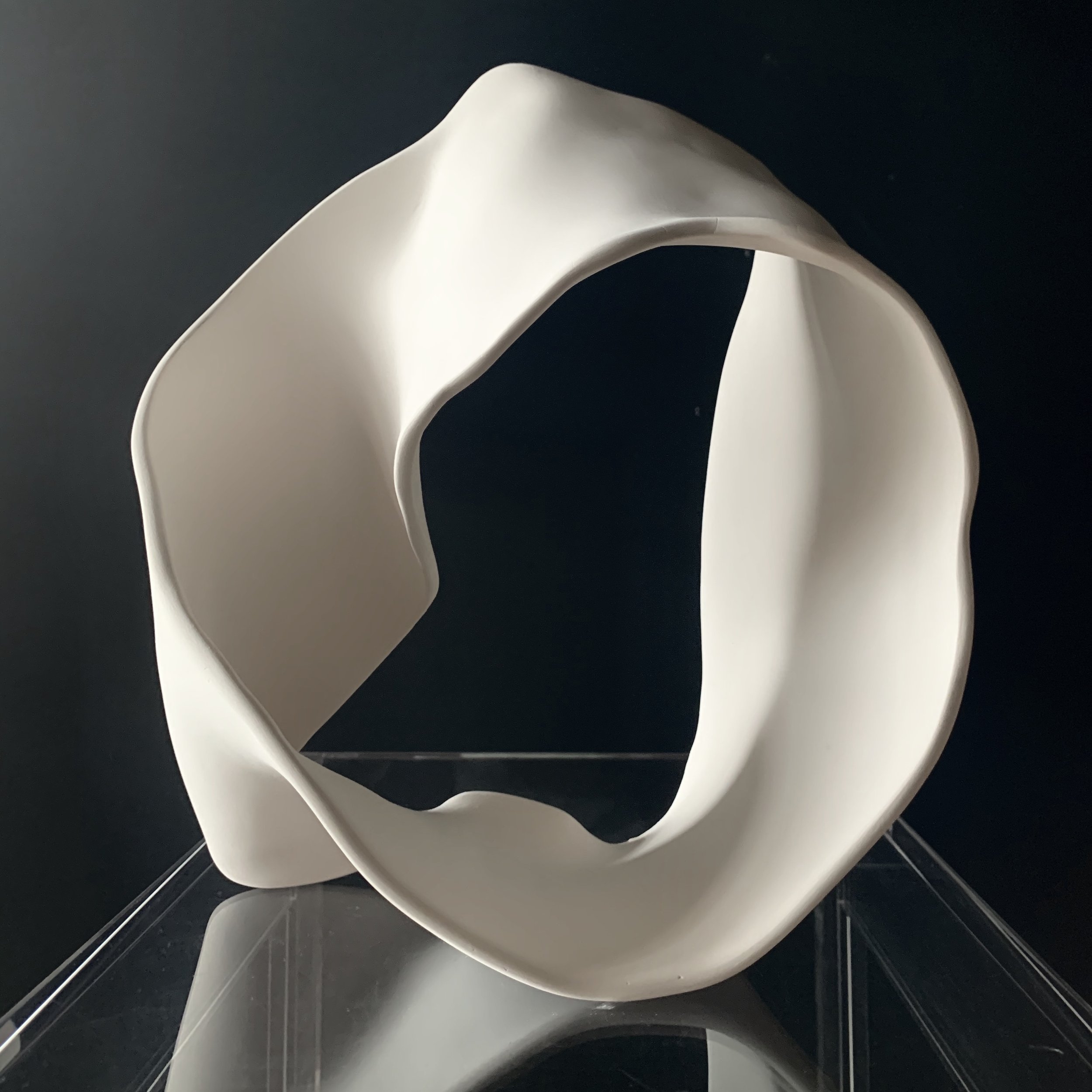 A porcelain Mobius Loop Sculpture by LAURA CLARK as featured in Blink Art Catalogue