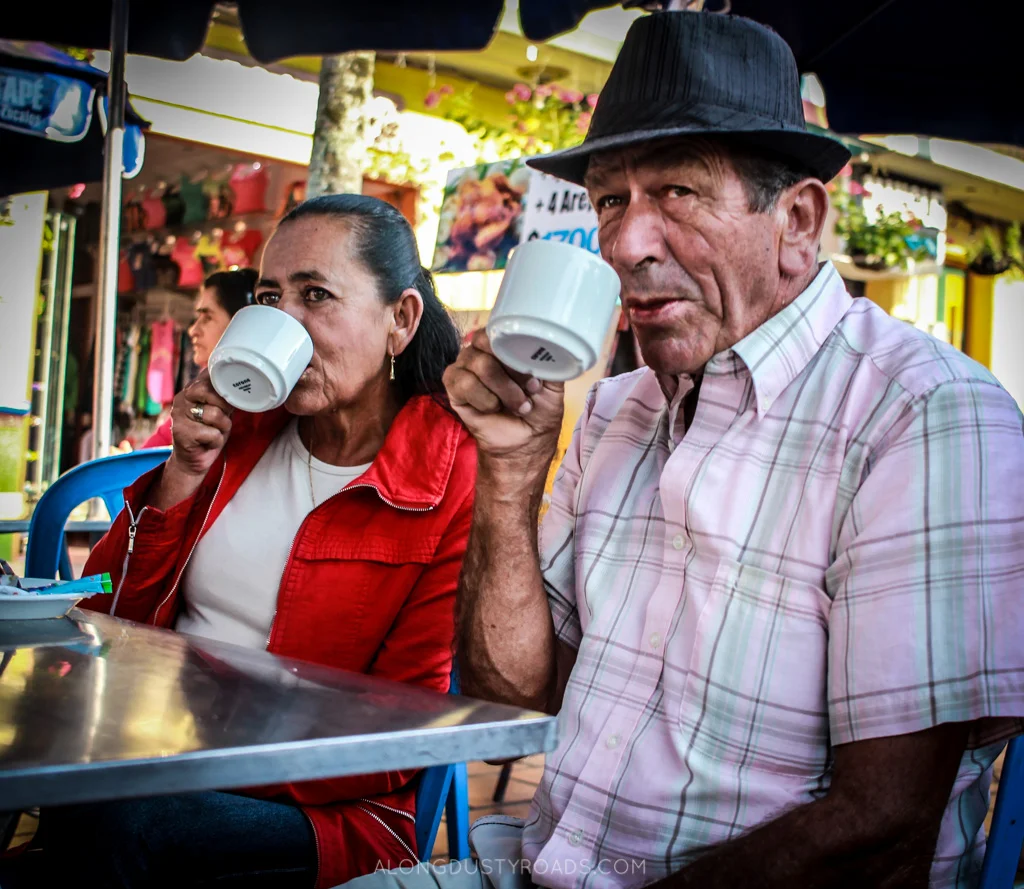 Things to do in Guatape Colombia - man and lady drinking coffee guatape colombia