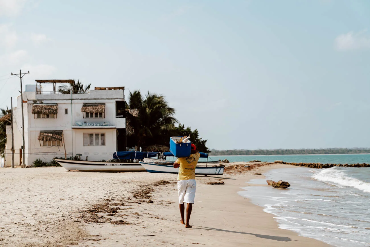 A Guide to Rincon del Mar | Fisherman walking along the beach