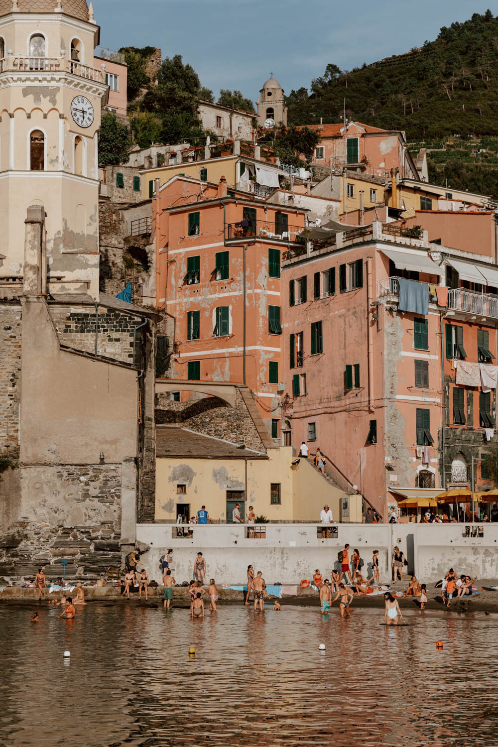 Vernazza harbour beach with colourful buildings in background
