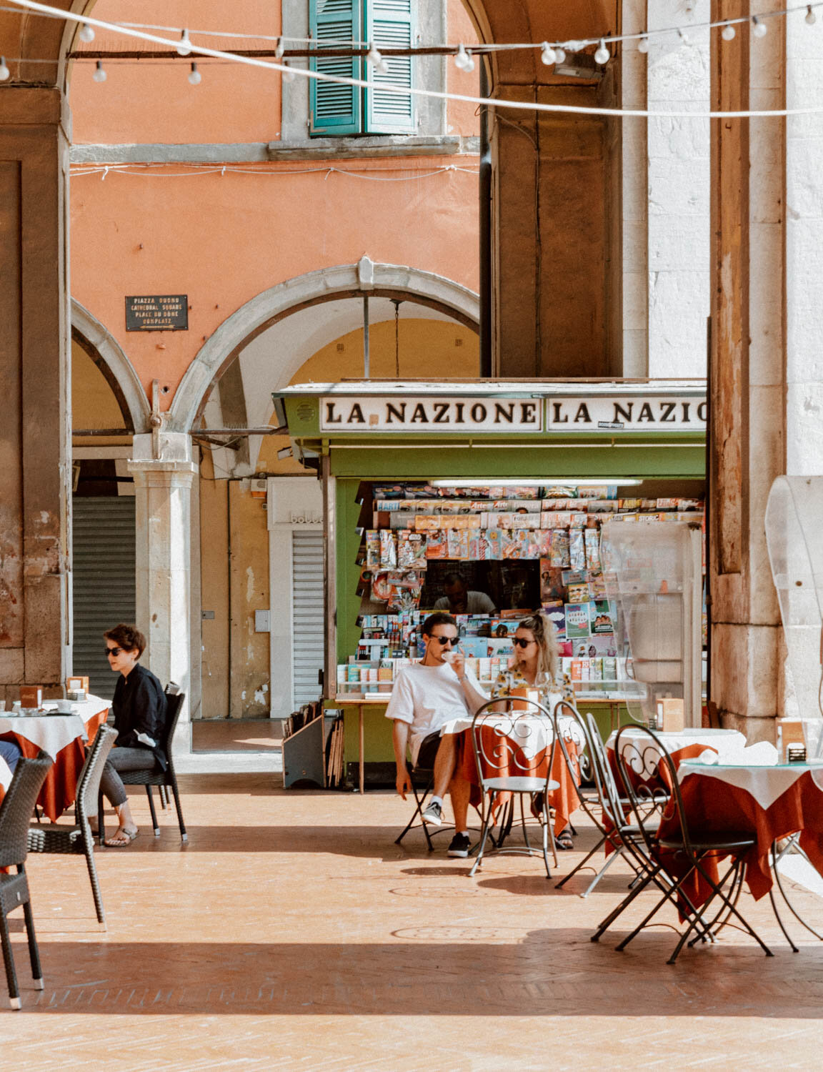 couple drinking coffee in small piazza