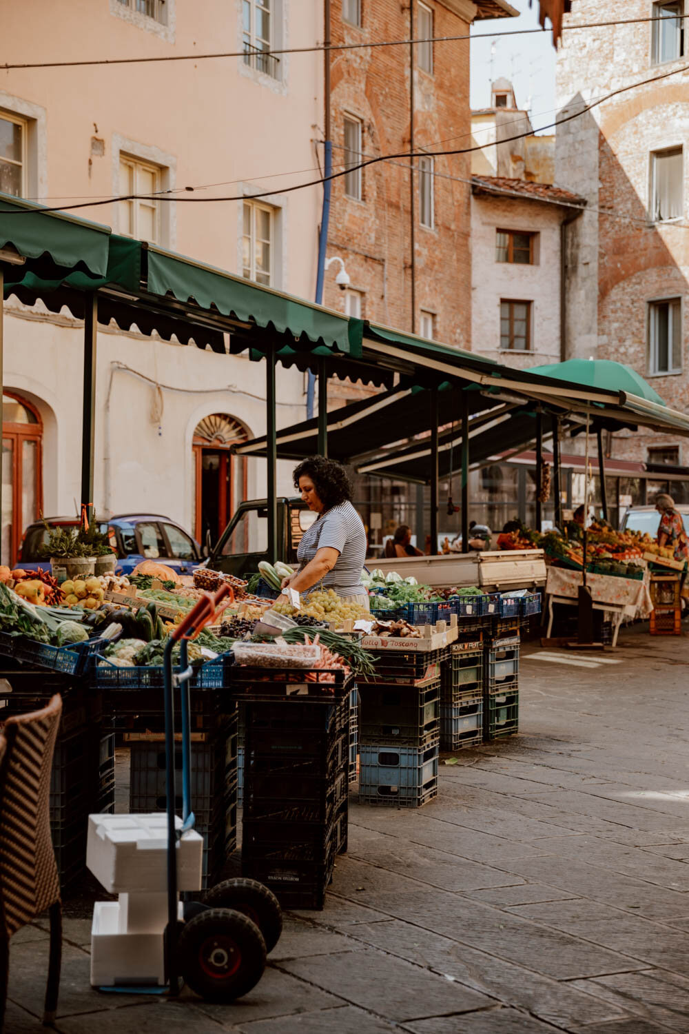 market stall seller and produce at mercato delle vettovaglie
