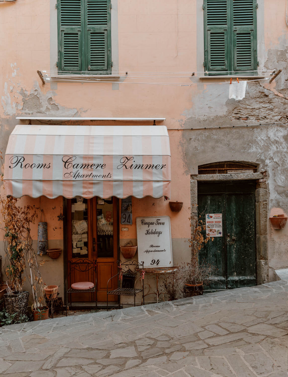 apartment rental office with pink and white awning