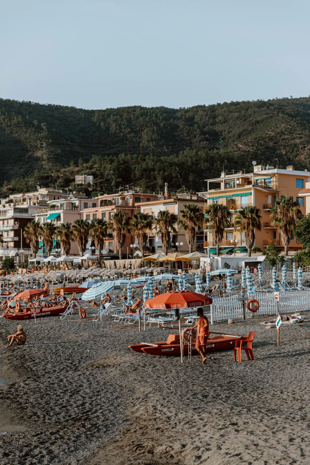 lifeguard under red parasol at baia delle favole