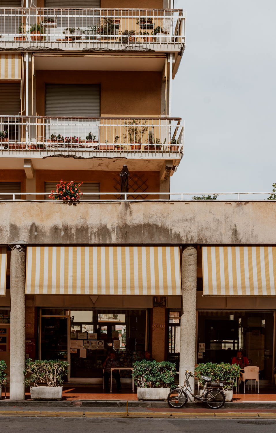 1970s building with yellow and white striped awnings