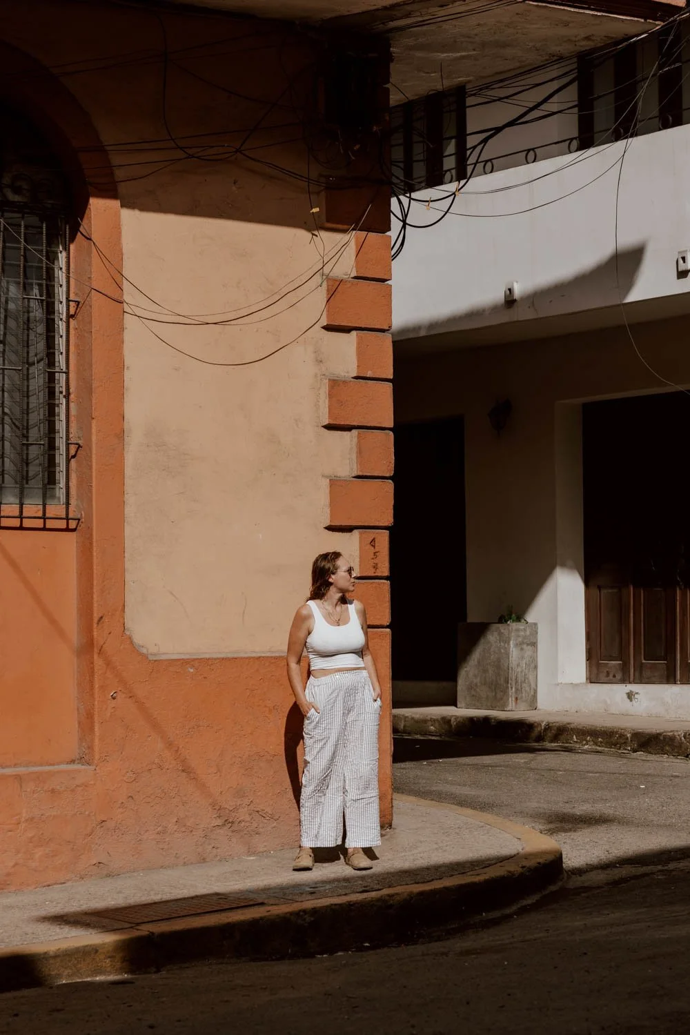 girl stands on colourful street corner