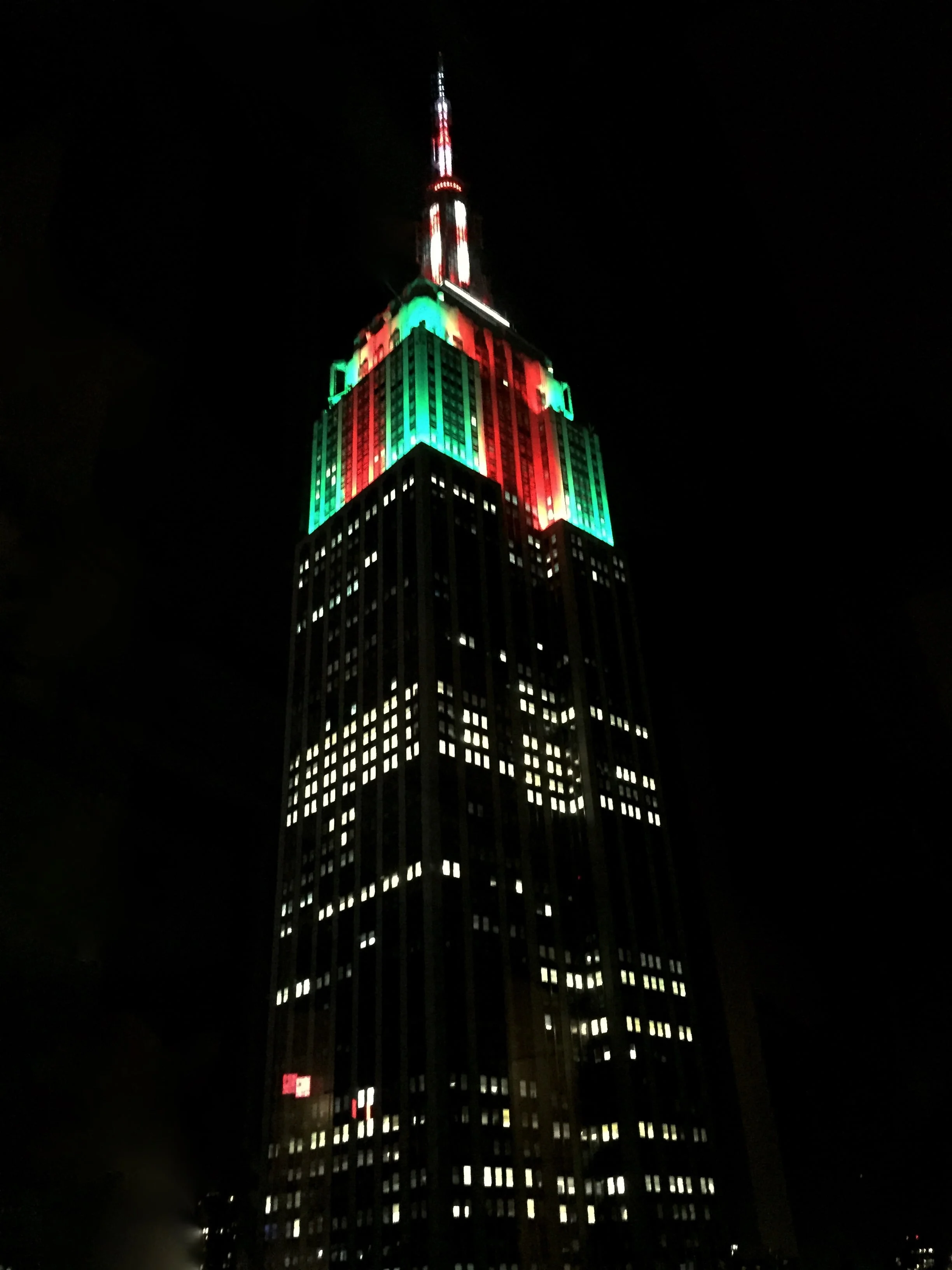 Empire State Building lit up in red and green.