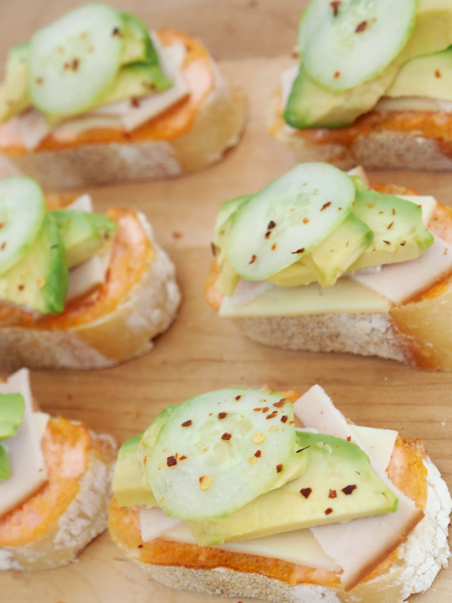 Close-up view of the mini open faced turkey avocado sandwiches.. YUM.