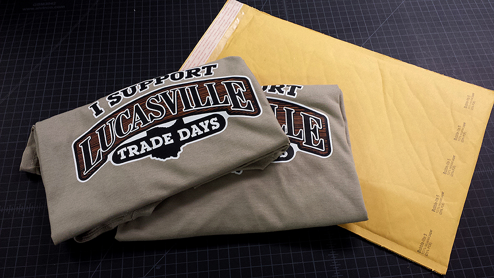 Two khaki shirts prepare themselves for the rough and tumble journey as they are shipped to their new home. We have many other shirts like these, in various sizes, looking for a new home. Show your support for the Lucasville Trade Days event by giving another homeless shirt a new life by welcoming it into your home. :-)