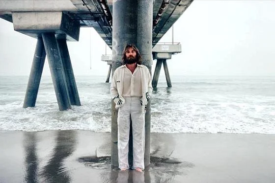 I thought about putting an actual photo of a young Charles Manson with his guitar here, but I decided that was creepy and unsettling. So here's a lovely image of Dennis Wilson on the beach. Much better!