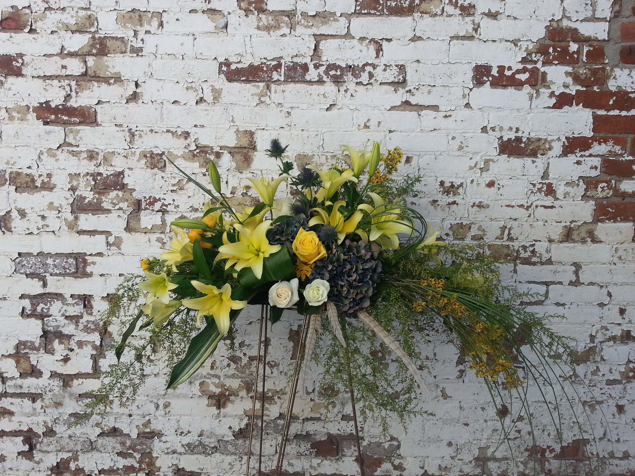 $200 Yellow Lily, Feathers and Bear Grass Casket Spray