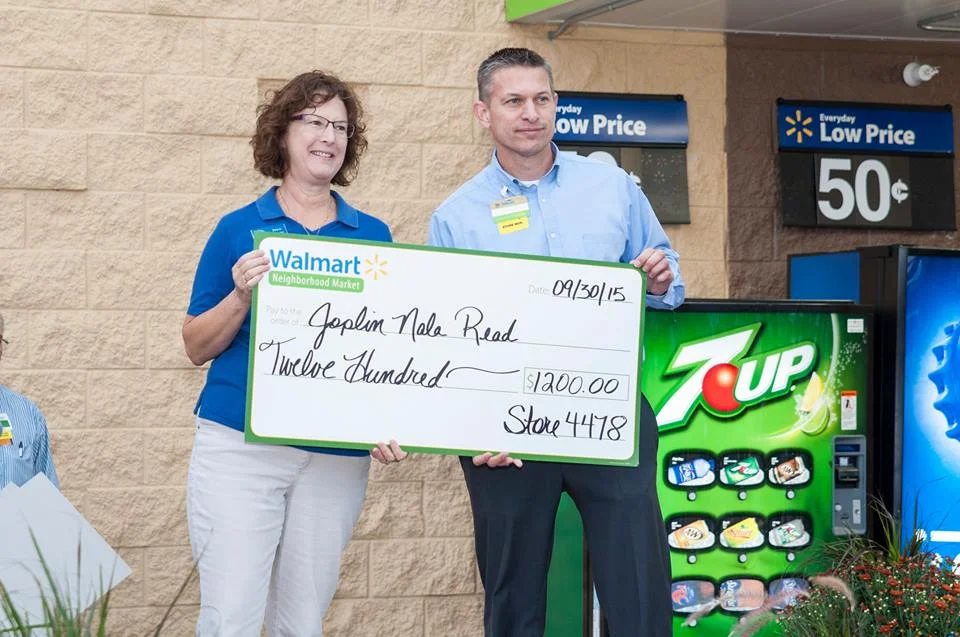 Joan Doner, Joplin NALA Read Program Coordinator, accepts a grant at the grand opening of Walmart Neighborhood Market Store #4478 in Joplin, MO.