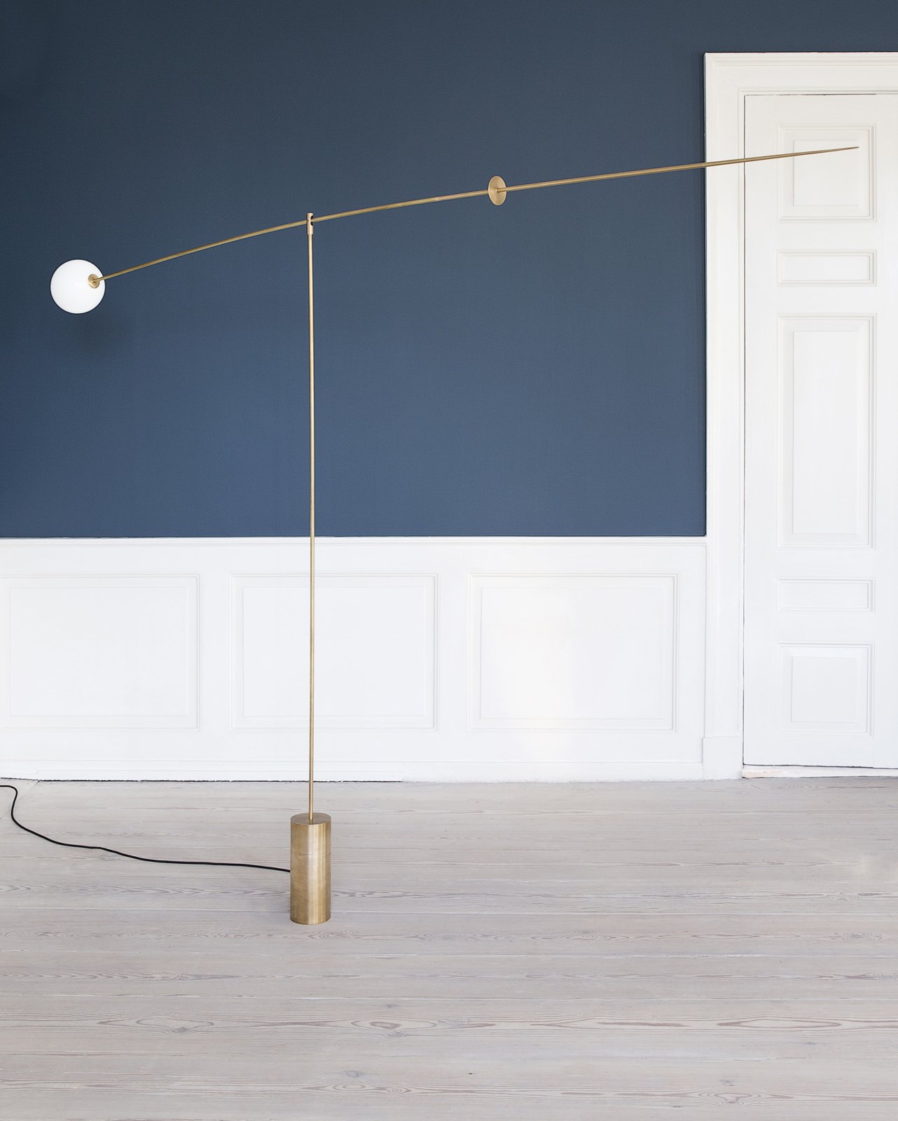 modern mobile floor lamp in brass by michael anastassiades