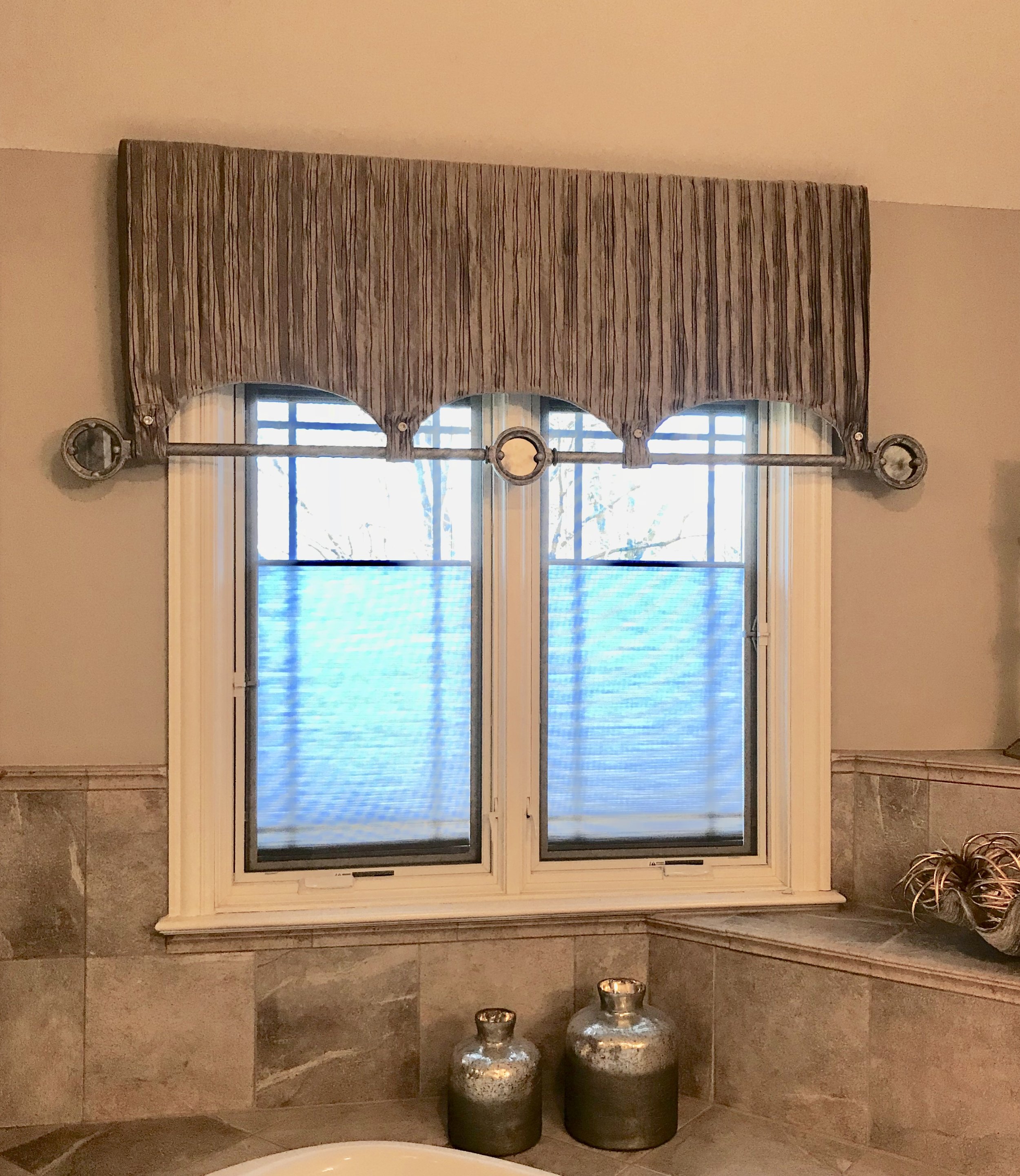 Ruched silk, pewter metal and antique mirrors combine to form this unique cornice.