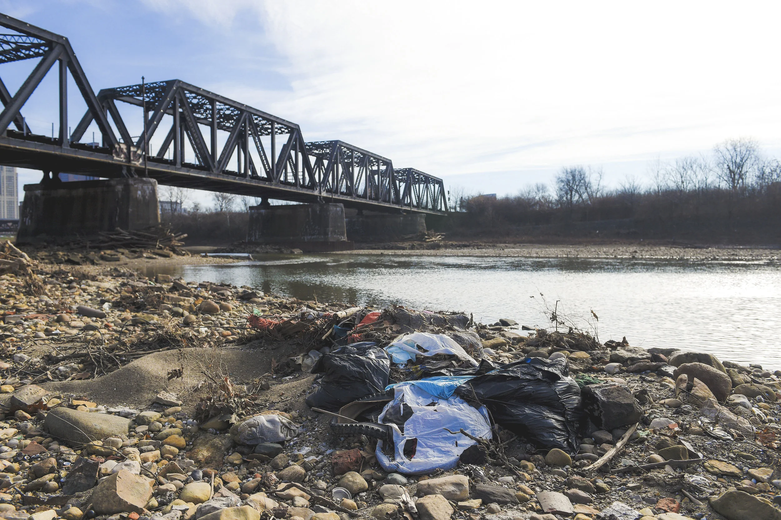 A mound of trash lay on the east shore of the Scioto River only 50 yards from the newly built Scioto Mile.