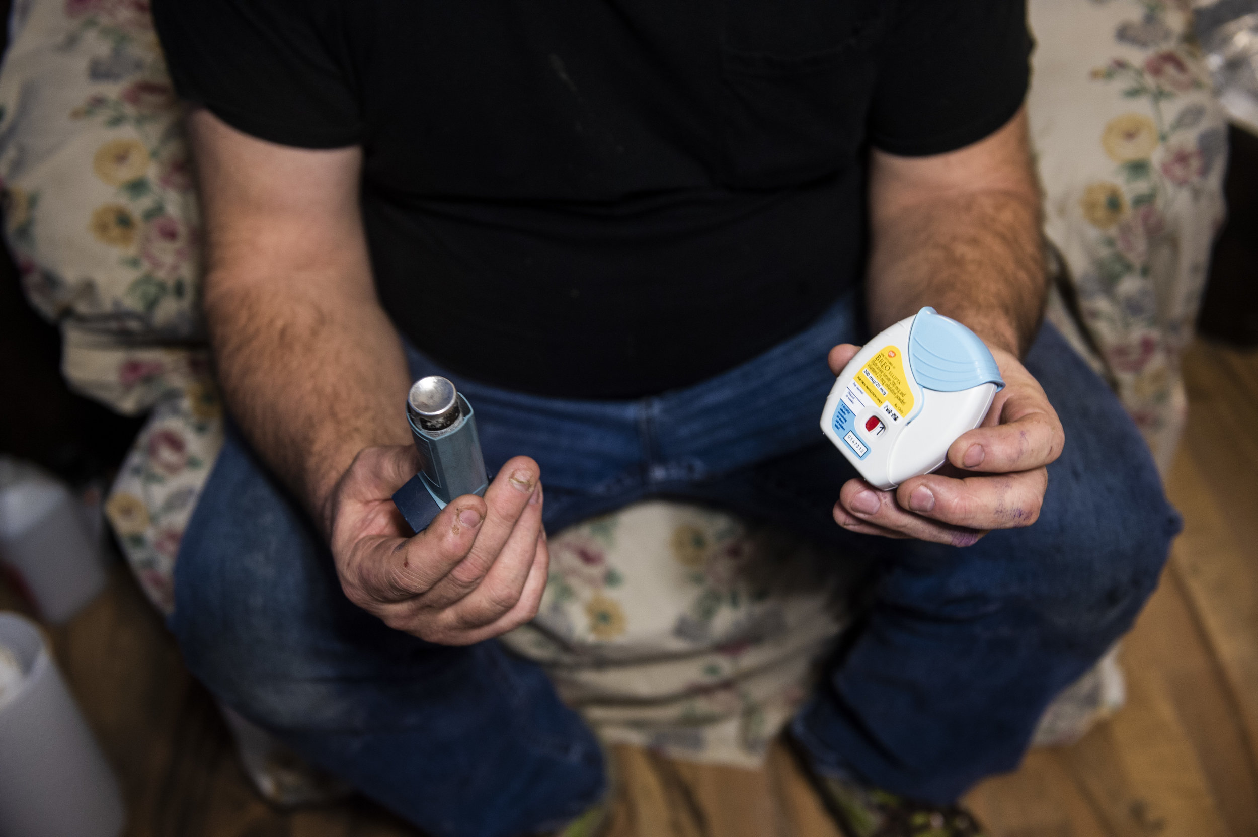 Harold Dotson shows the two inhalers he uses when he has breathing episodes due to his Black Lung Disease on Thursday, January 17 in Paw Paw, Kentucky. 