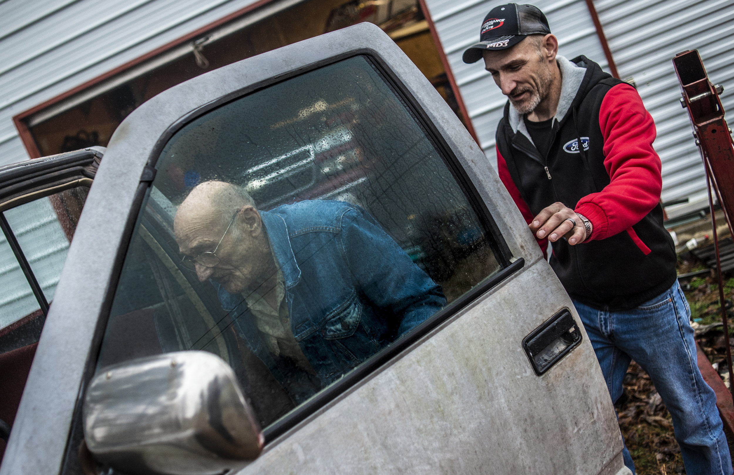  Jackie Yates helps his father Verne to his truck after Verne delivered a transmission for a truck that Jackie is working on to his house in Cedar Bluff, Virginia on Friday, January 18. Verne, who worked much of his life in the coal mines, has stage 