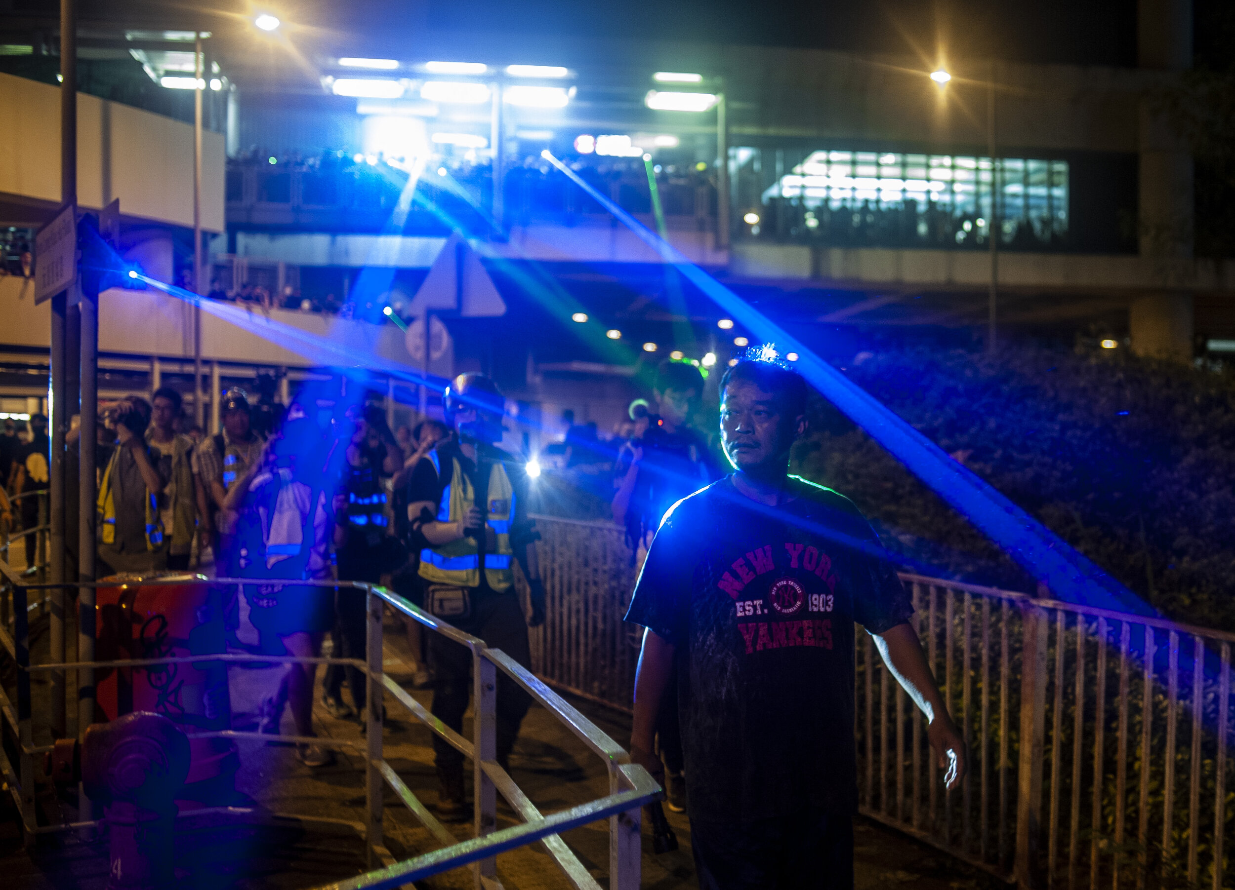  Protesters occupying Yeung Long Metro Station shine high powered laser pointers at a man who expressed pro-Chinese sentiments and argued with pro-democracy protesters during a sit-in protest held at the Yeung Long Station on August 21, 2019. The pro