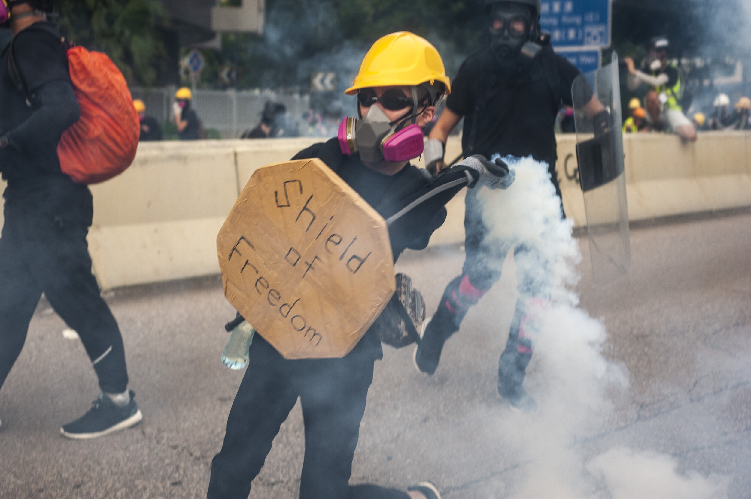  A pro-democracy protester hurls a tear gas canister back at riot police during a violent confrontation between police and protesters in Kwun Tong on August 24, 2019. What had began as a march to protest surveillance and facial recognition technology