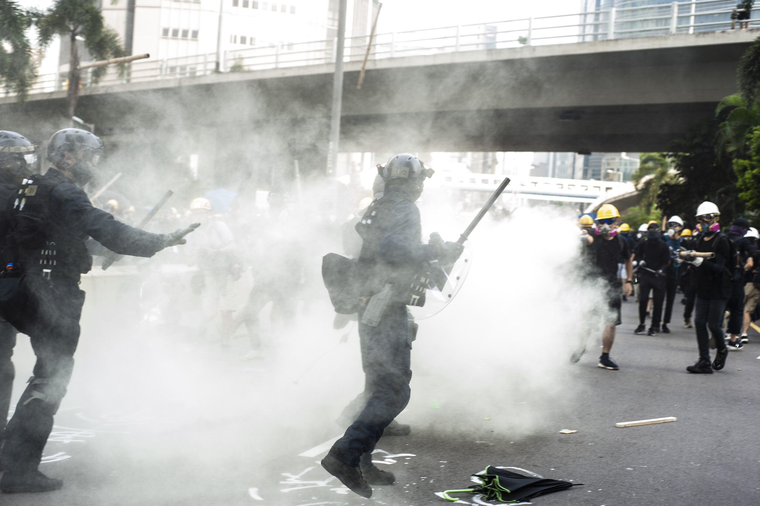  Several police officers retreat briefly after being outnumbered and beat by protesters wielding bats, iron rods, and fire extinguishers during a violent clash in Kwun Tong on August 24, 2019. Following a tense standoff between police and pro-democra