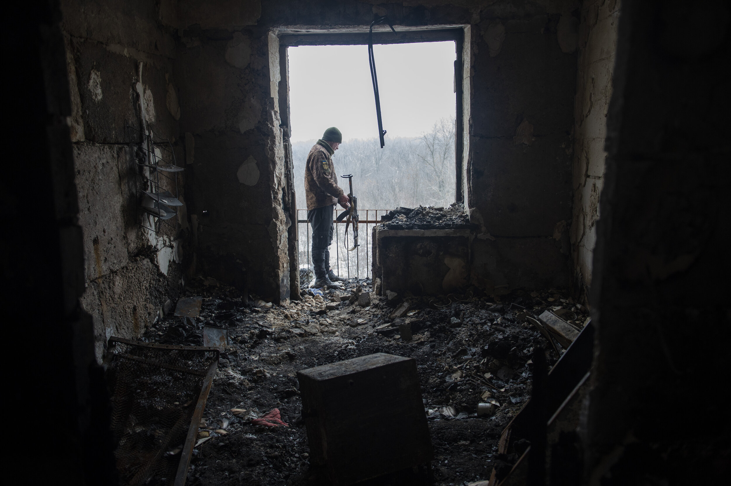  A Ukrainian soldier inspects the damage to a building in Zolote-4 that was hit by a rocket during a night of intense fighting on February 25, 2019. Firefights are a common occurrence near ‘Point Zero’ in Zolote where Ukrainian military and Russian b