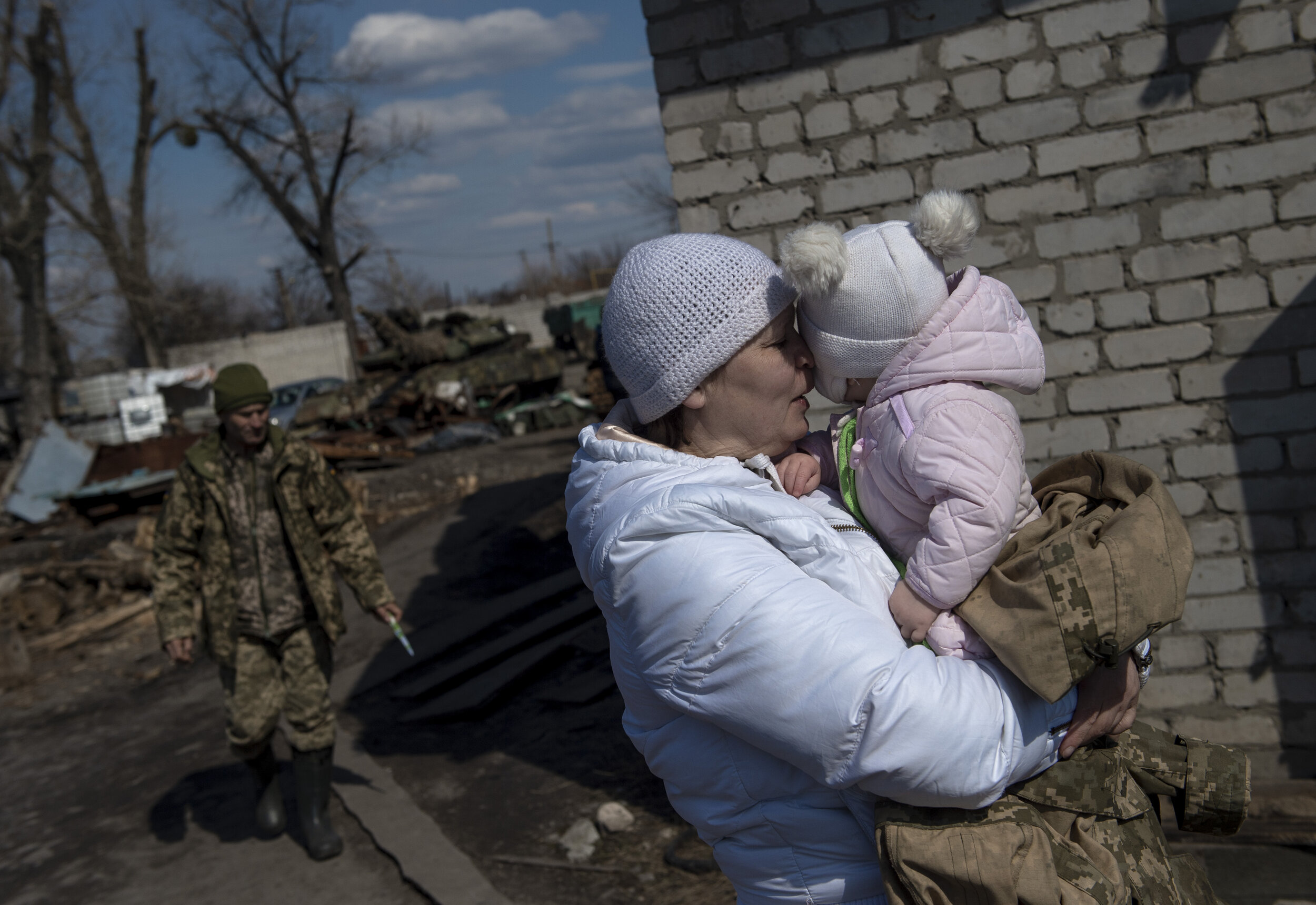  A woman embraces her granddaughter while visiting the young girl’s father at a military outpost several miles from the frontlines. While most soldiers find themselves spending months at a time away from loved ones, others find themselves stationed n
