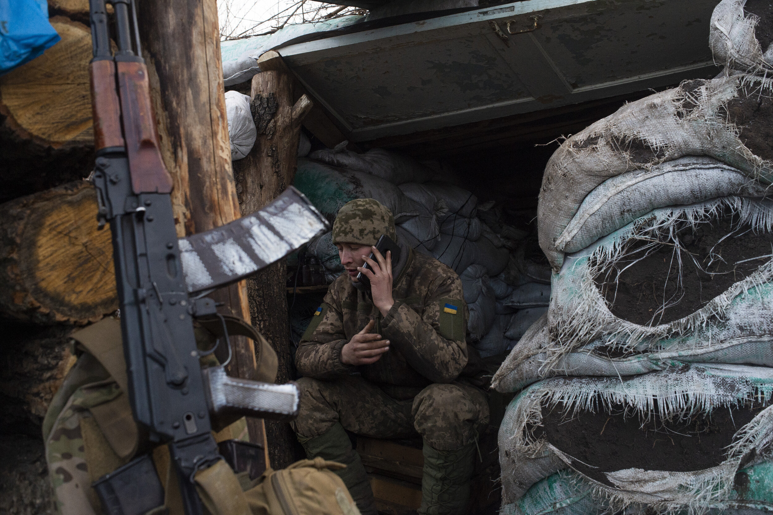  A soldier of the 54th Mechanized Rifle Brigade speaks to his wife on his phone while manning the front position of ‘Point Zero’ in Zolote-4 on February 28, 2019. Periodic bouts of quiet often breed boredom and anxiety in the soldiers, who find thems