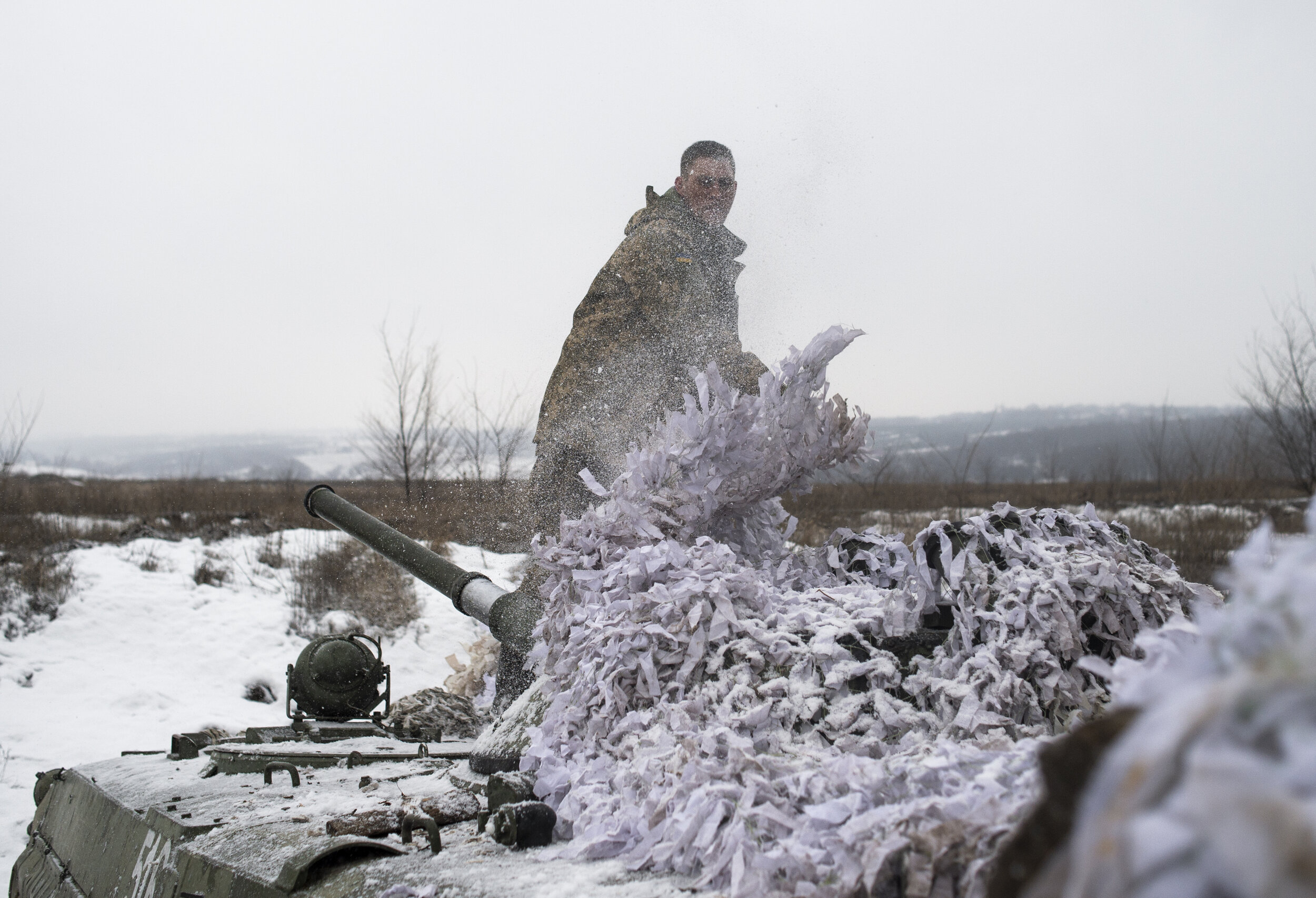  A Ukrainian soldier rips the netting off an armored personnel carrier on the outskirts of Zolote on the frontlines near Luhansk in eastern Ukraine. While many regard the Donbas War as a frozen conflict places on the frontlines such as Zolote and Avd