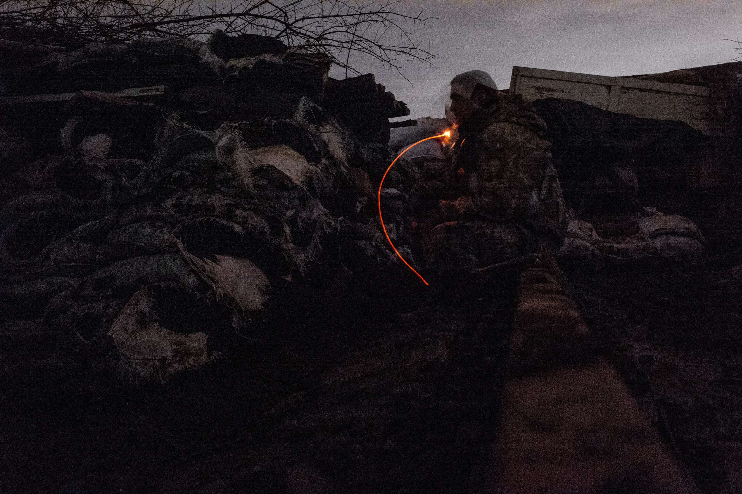  A Ukrainian soldier smokes a cigarette at ‘Point Zero’ in Zolote-4 as nightly firefights kick-off between soldiers and Russian backed separatists.  While occasional gun battles occur throughout the day time, heavy fighting is reserved for the night.