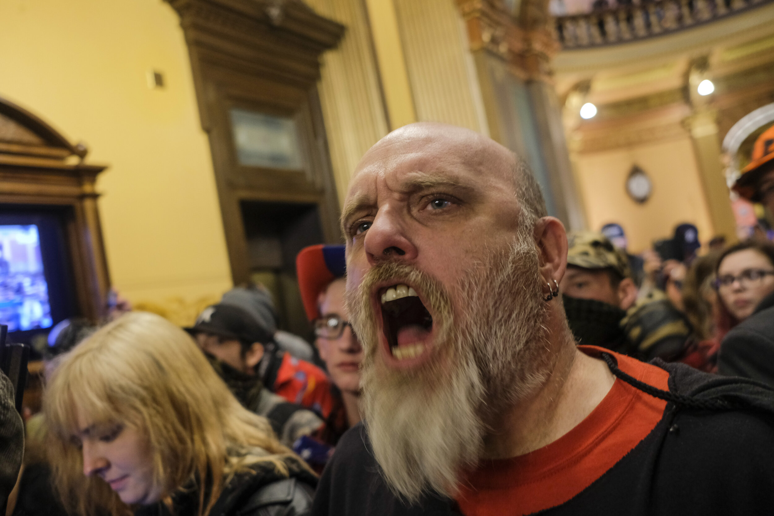  Anti-lockdown protesters, some armed with assault rifles and military grade equipment, chant slogans and deman Michigan re-open outside of the senate chamber at the Michigan Capitol Building in Lansing, Michigan on Thursday, April 30. As the nation’